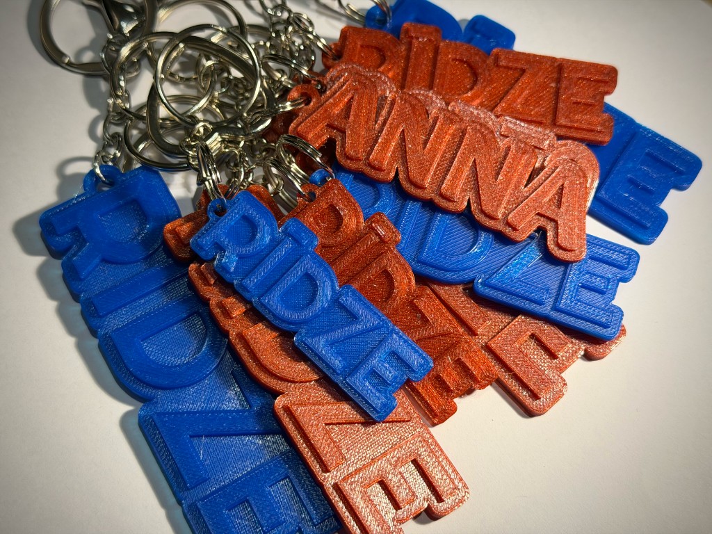 3D drukāti piekariņi ANNA un RĪDZE zilā un oranžā krāsā